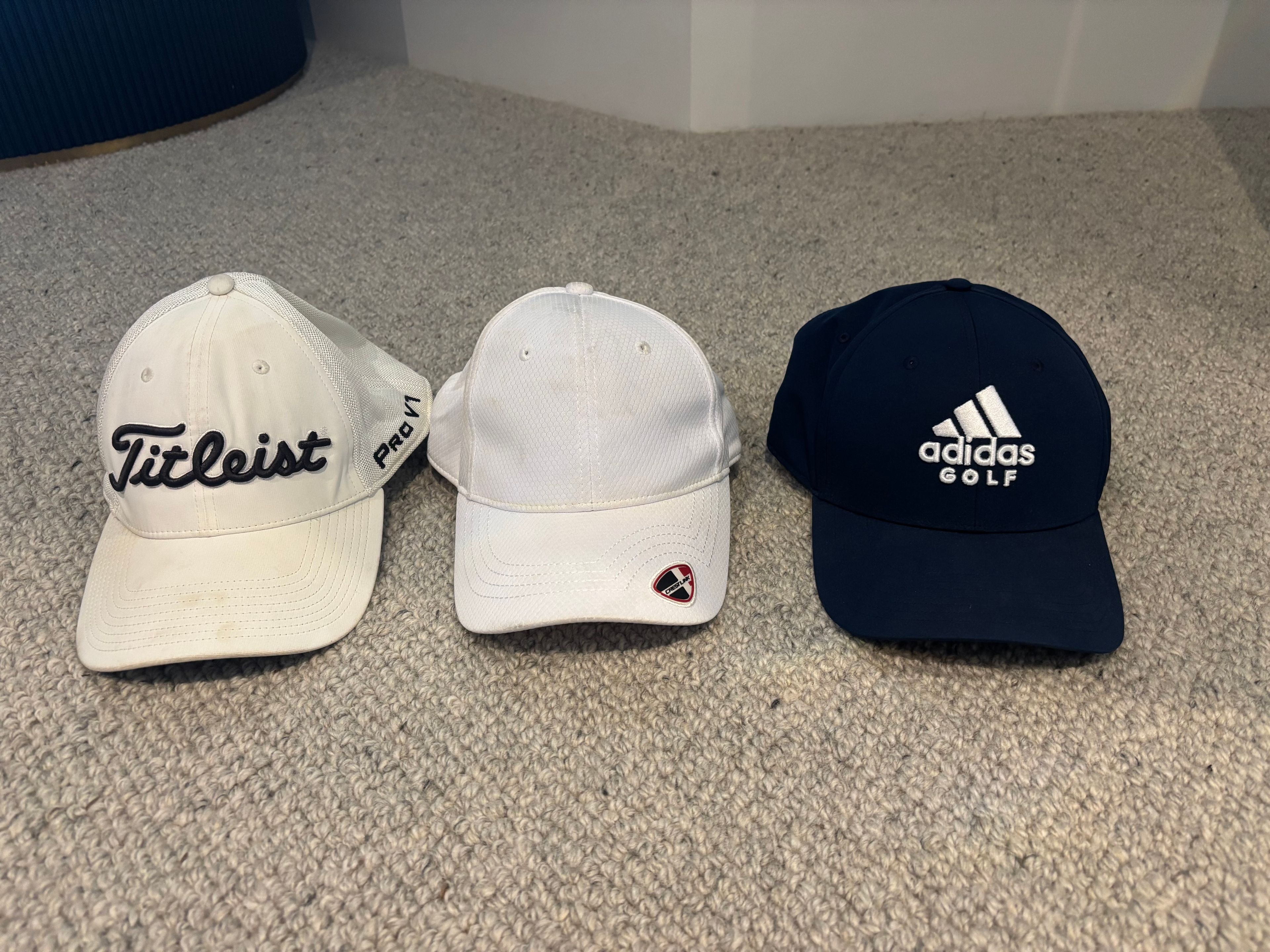 Various used golf caps